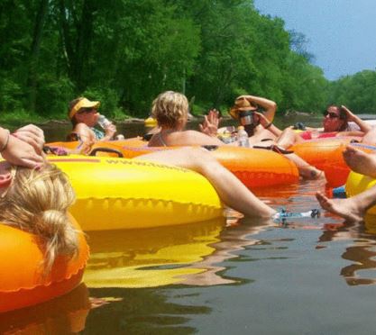 people floating on tubes in water